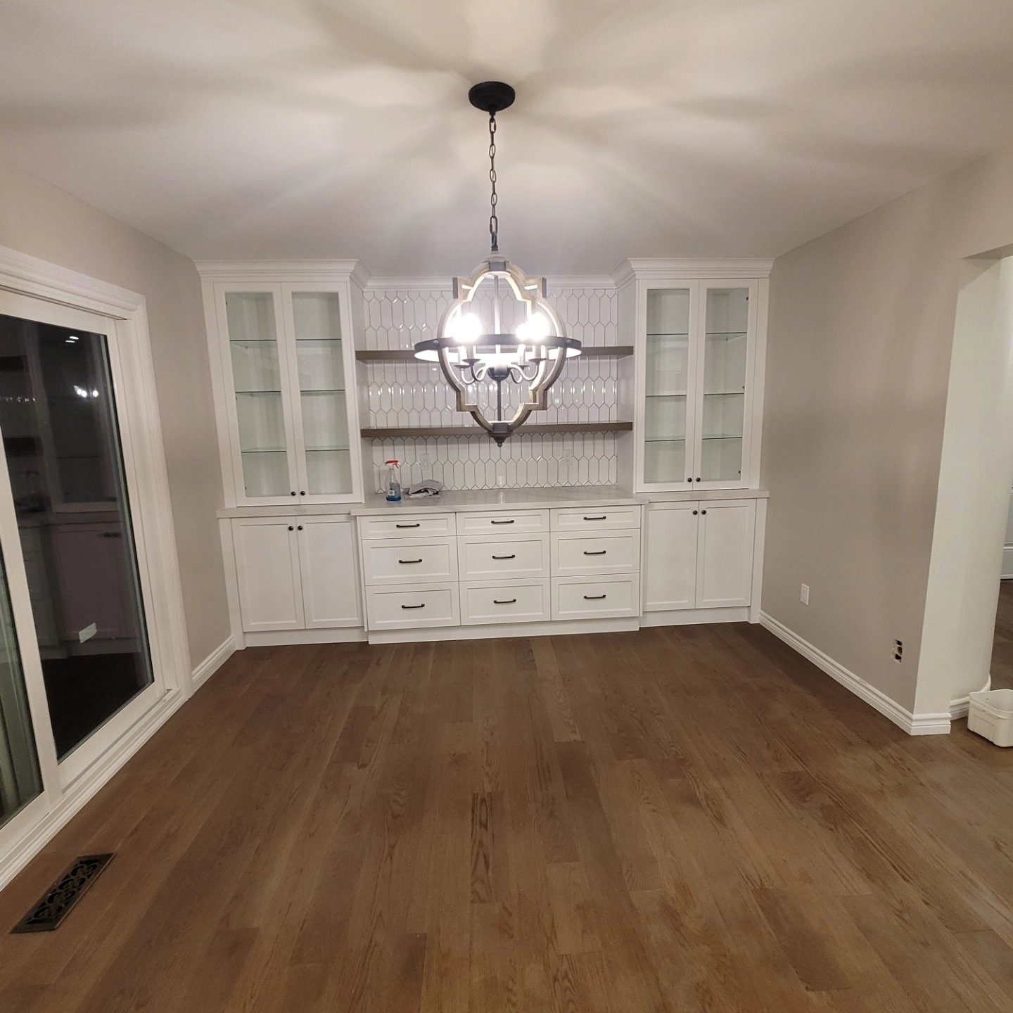 Built-in cabinetry wall with glass-front upper cabinets